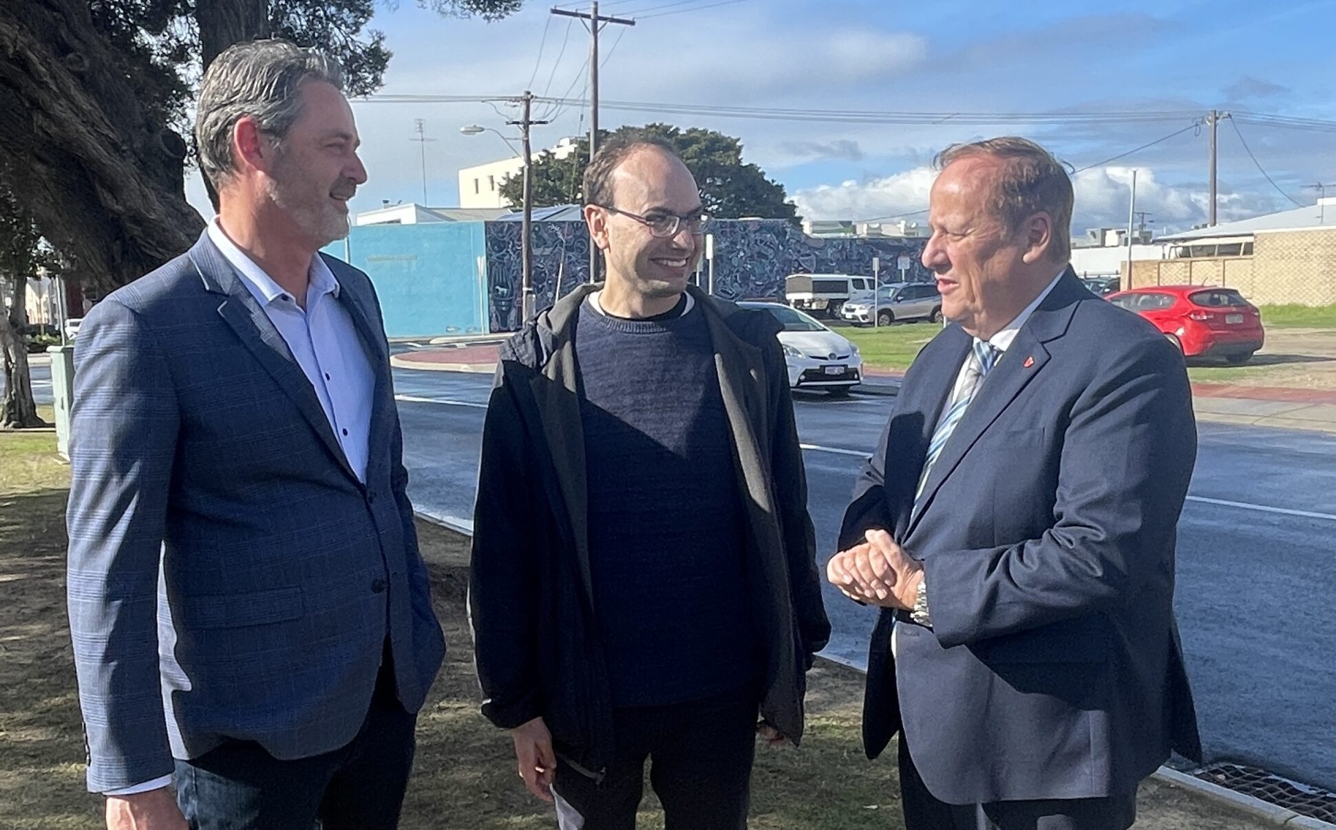 CEO Paul Fleay, Participant Michael and Minister Don Punch standing on a verge in Bunbury talking to each other.